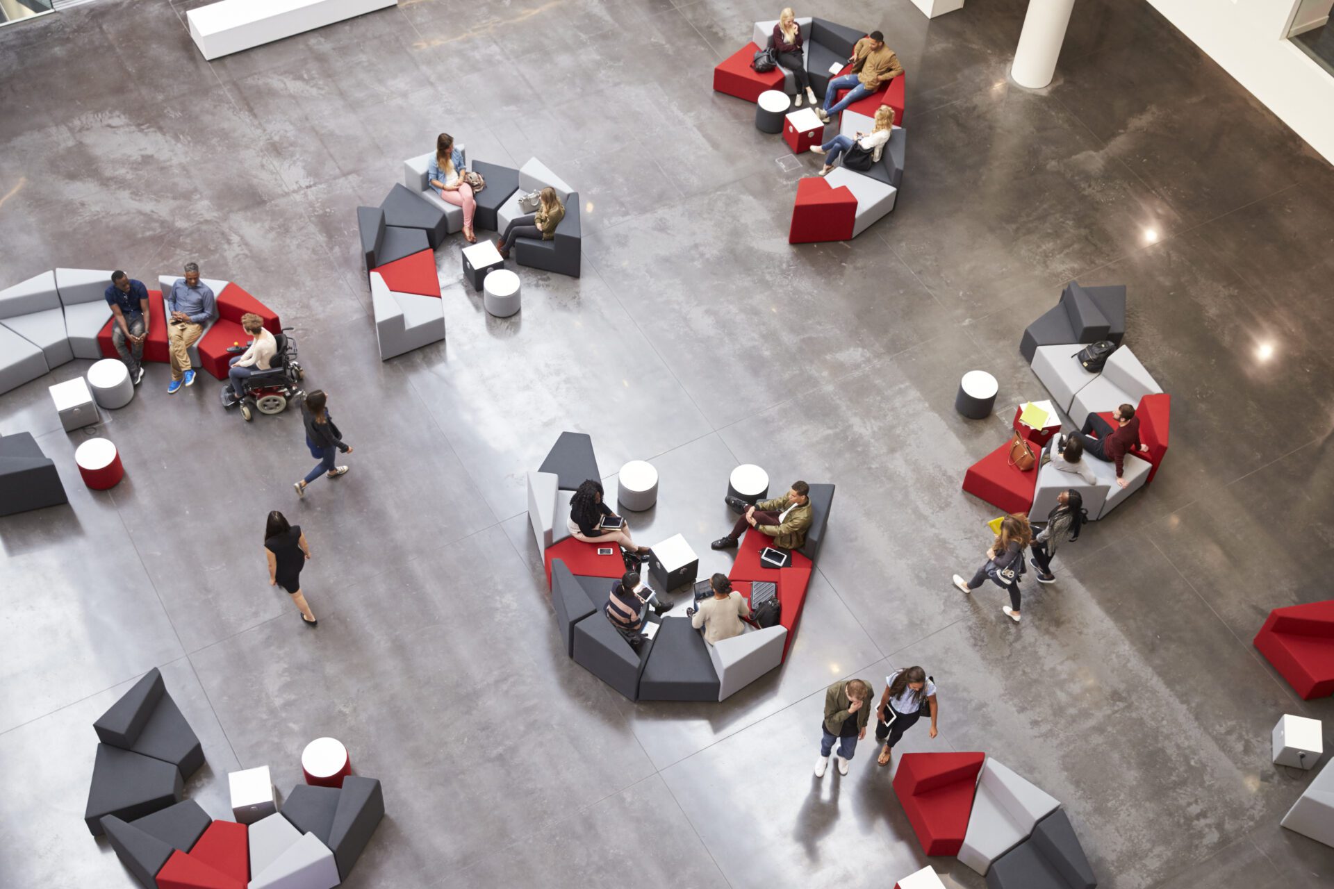 Students in the atrium of modern university, elevated view